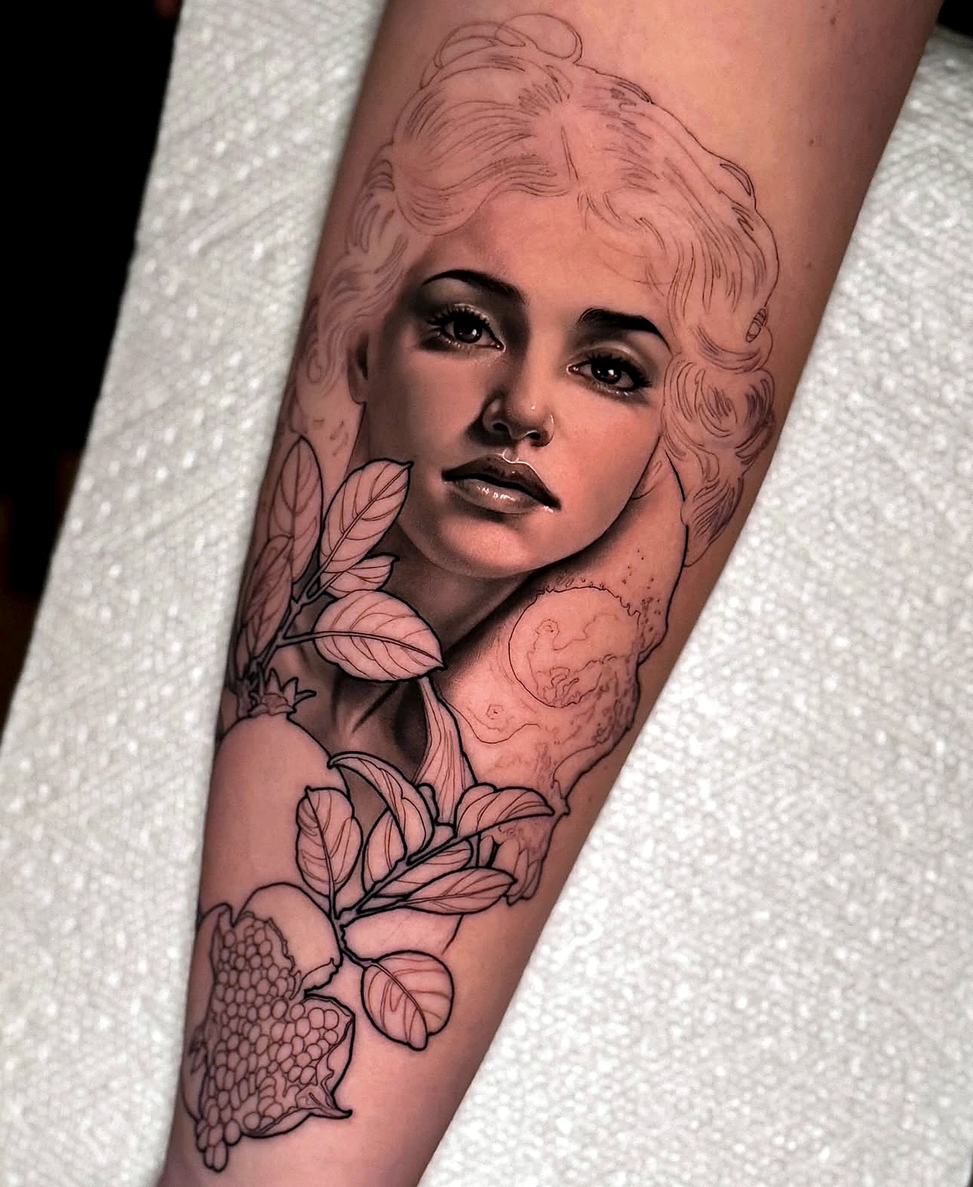 Black and grey realism portrait with floral skull by Rav Singh at Inkology