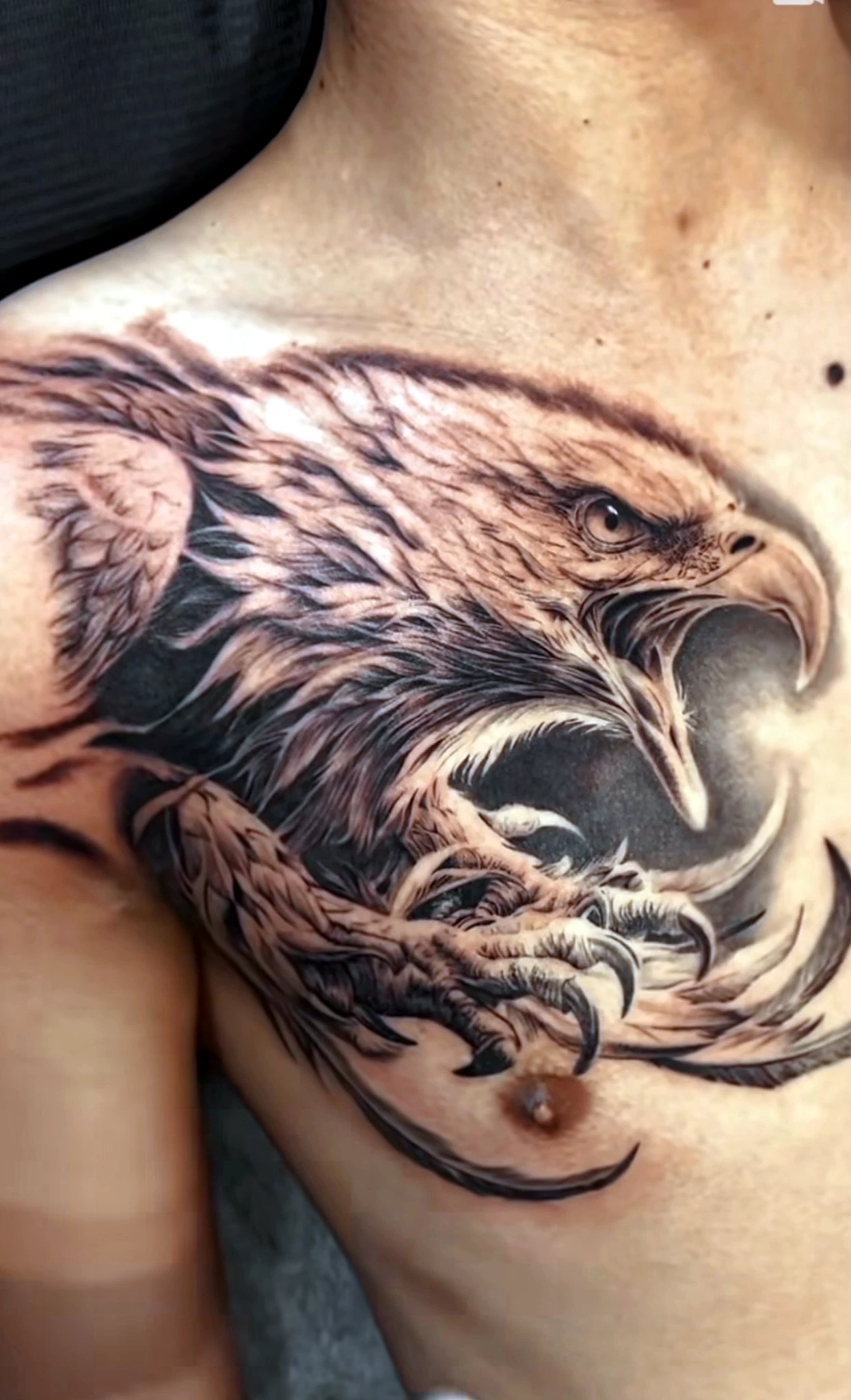 Black and grey realism eagle chest piece by Rav Singh at Inkology